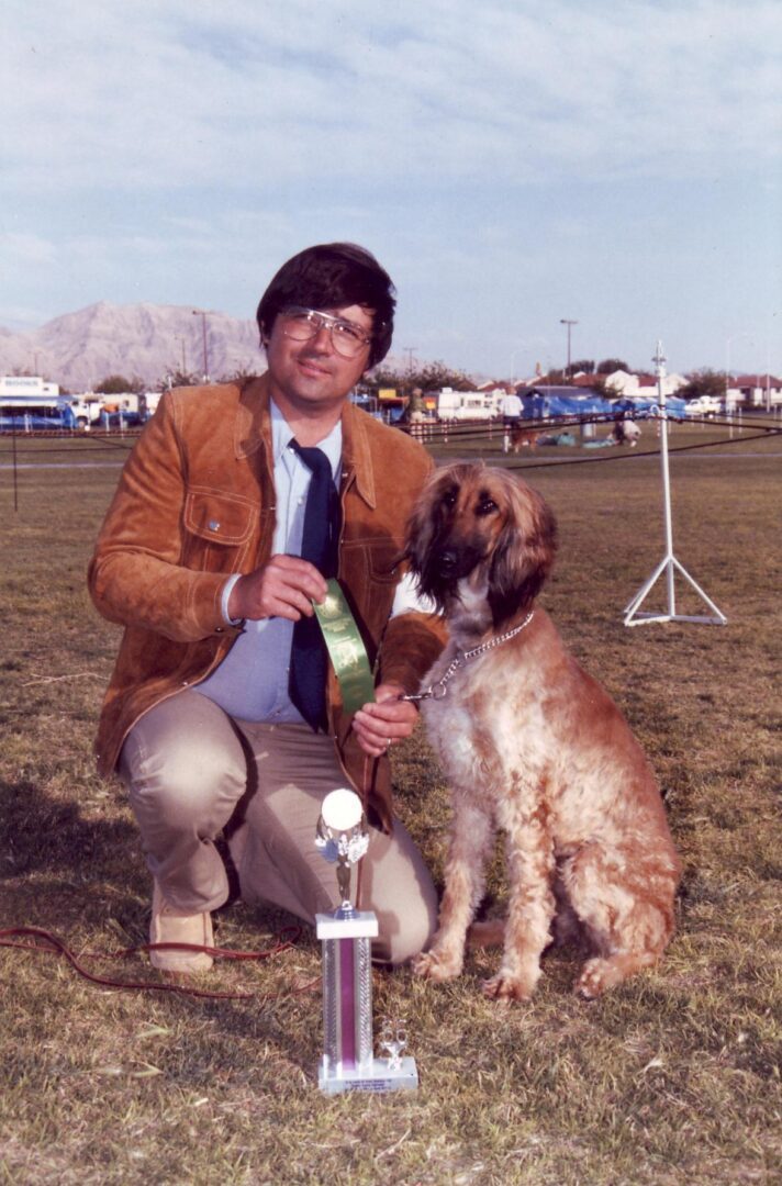 A man and his dog are posing for the camera.